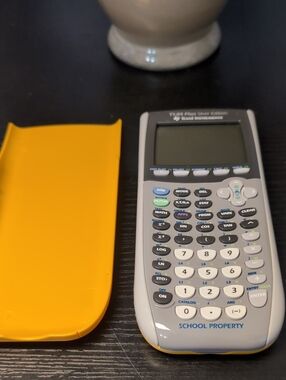 Texas Instruments Graphing Calculator with Yellow Slide Cover